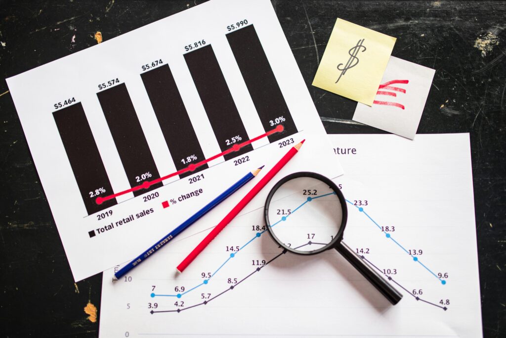 pexels-photo-7947758-7947758 Charts and graphs highlighting retail sales growth, utilizing a magnifying glass for detail.